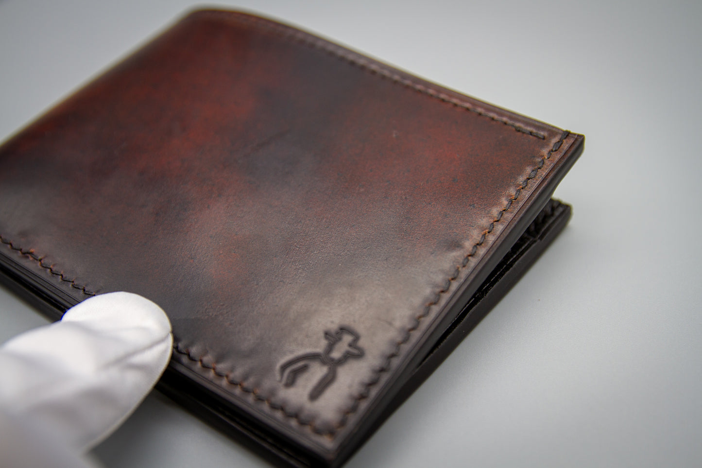 
                  
                    Back exterior of handmade marbled Horween shell cordovan bifold wallet
                  
                