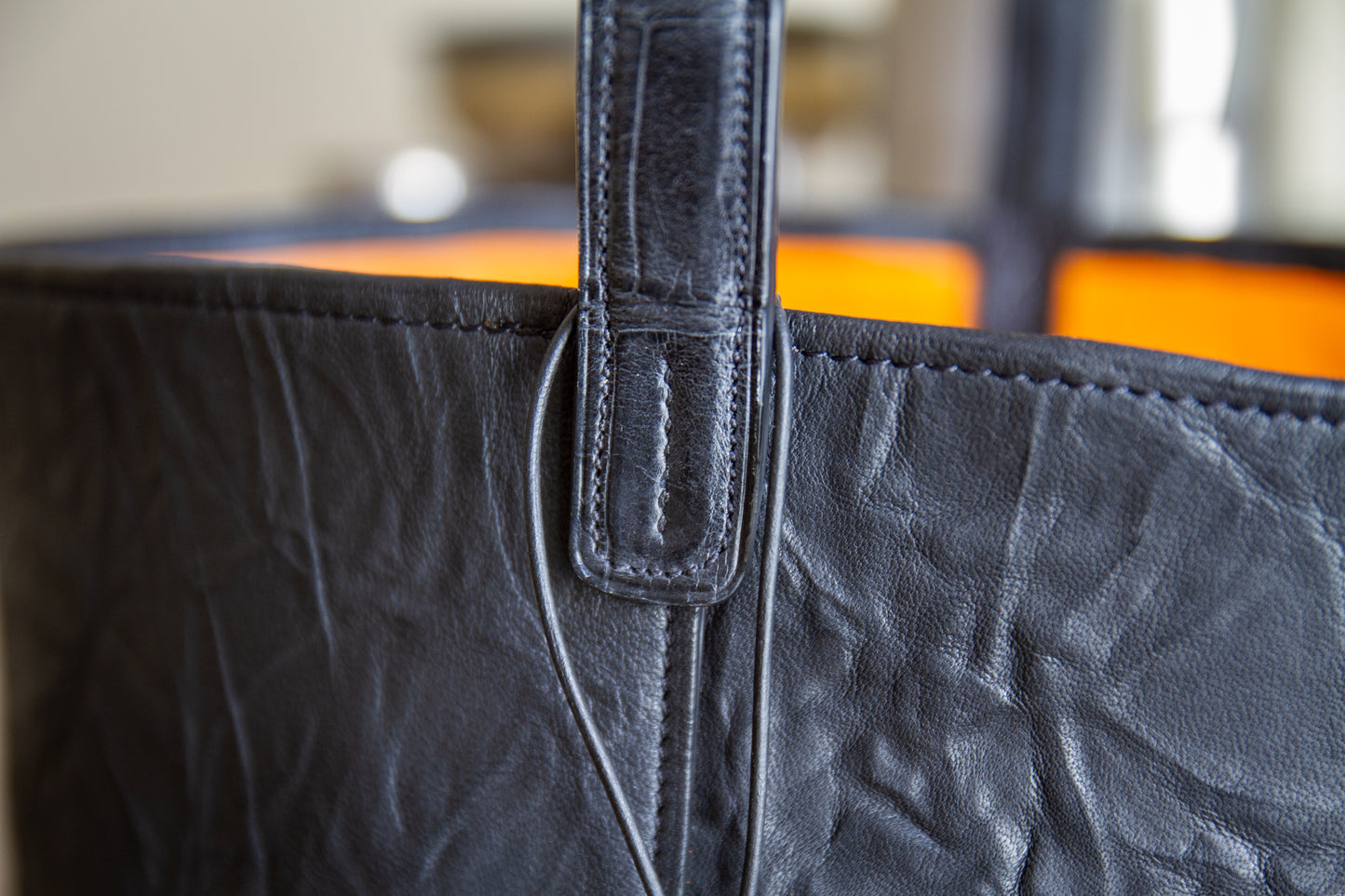 
                  
                    Close up on the alligator handle attachment and top opening stitching
                  
                
