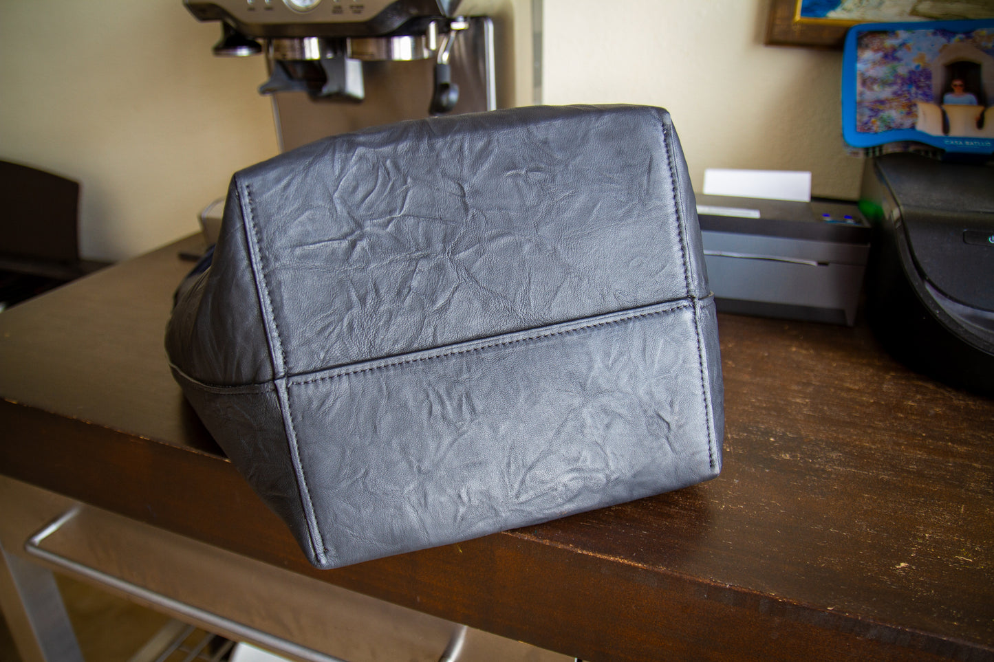
                  
                    Underside view of the tote bag showing the structured rectangular base and reinforced center seam stitching.
                  
                