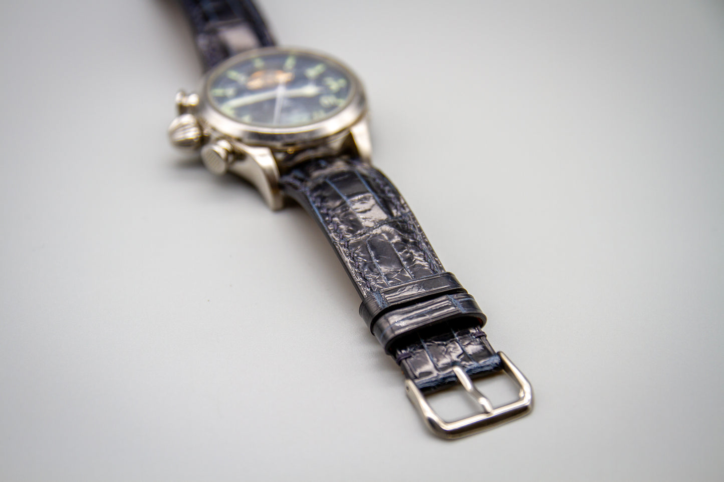 
                  
                    Handcrafted midnight blue alligator watch band flat lay
                  
                