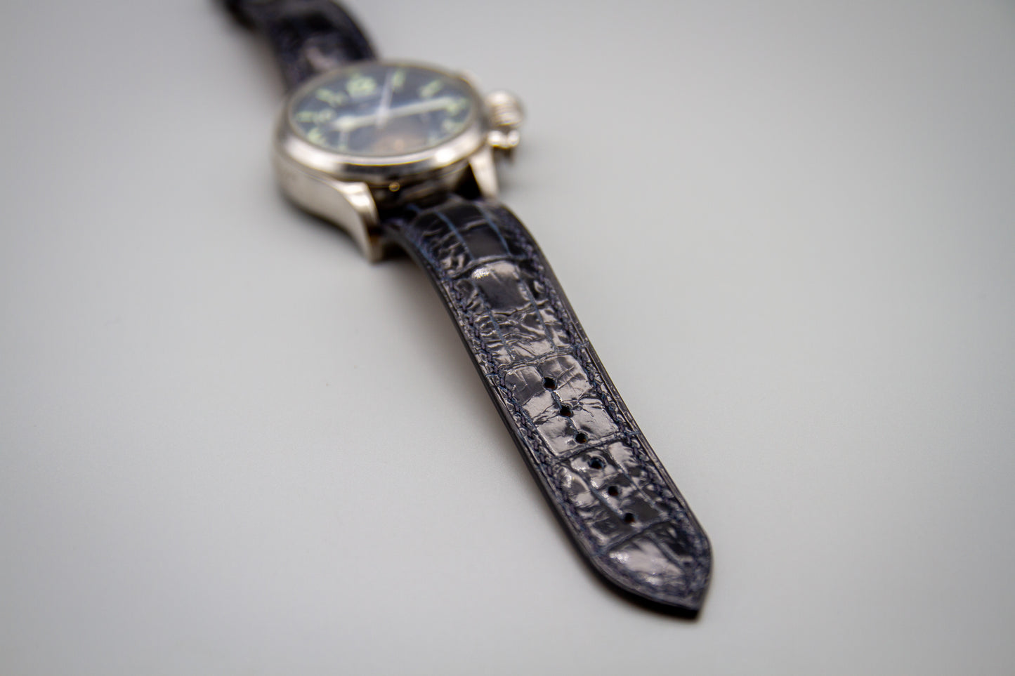 
                  
                    Close-up detail of midnight blue alligator scale pattern and edge finish
                  
                
