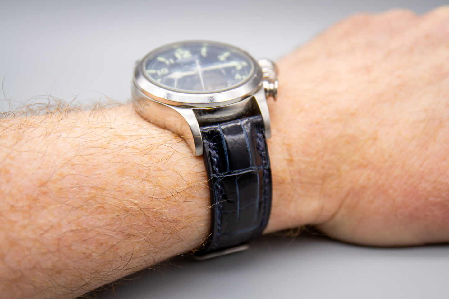 
                  
                    Midnight blue alligator leather strap mounted on a luxury watch
                  
                