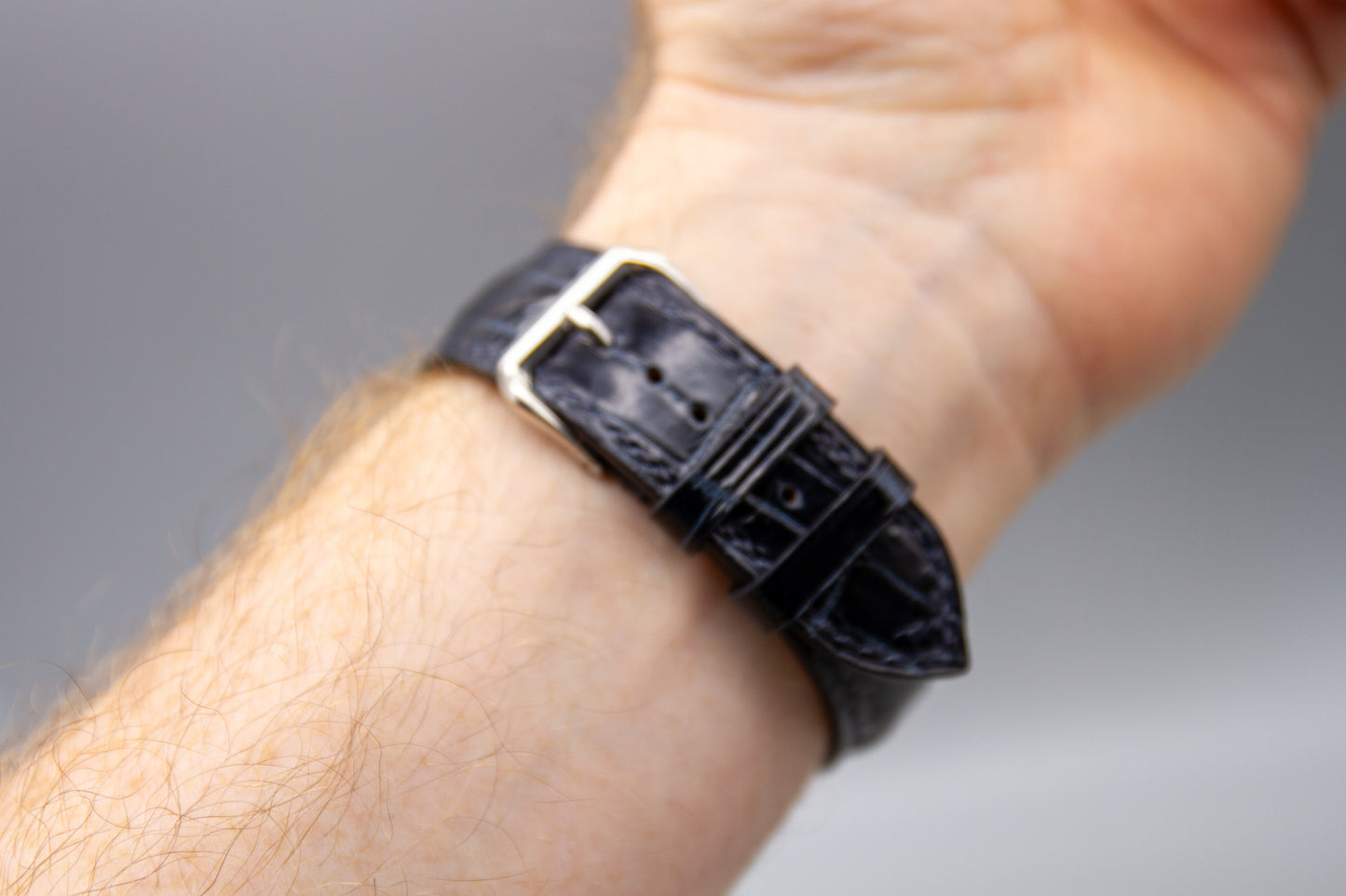 
                  
                    Custom midnight blue alligator watch strap on wrist
                  
                
