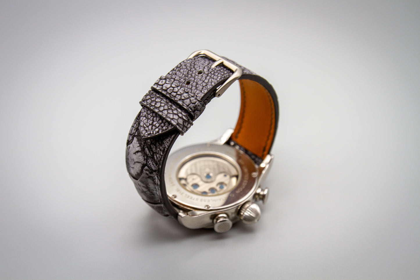 
                  
                    Close-up of hand-painted edges and scale pattern on grey ostrich leg watch band
                  
                