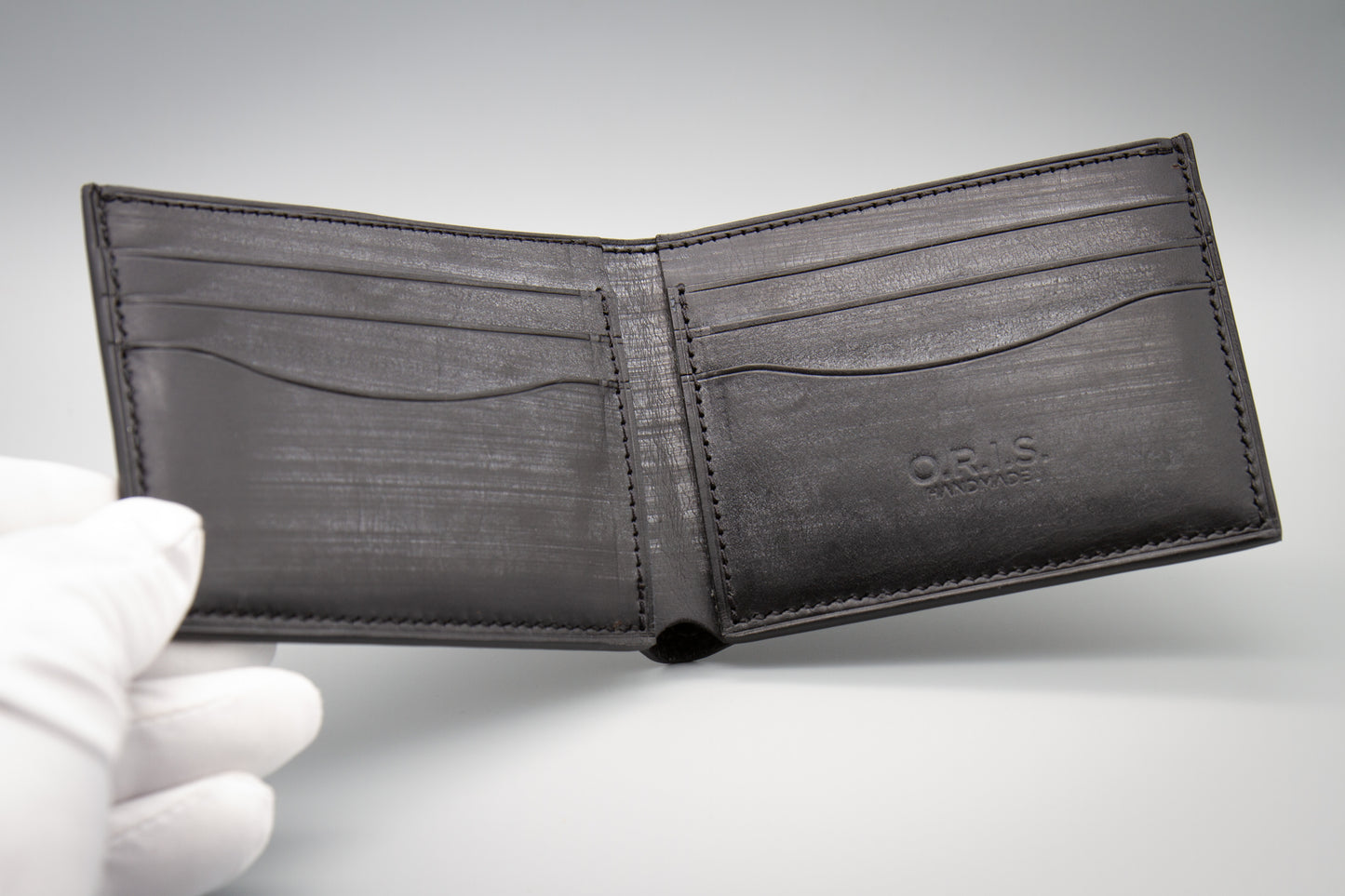 
                  
                    Open Italian Belfagor veg-tan leather bifold wallet showing card slots and cash pocket
                  
                