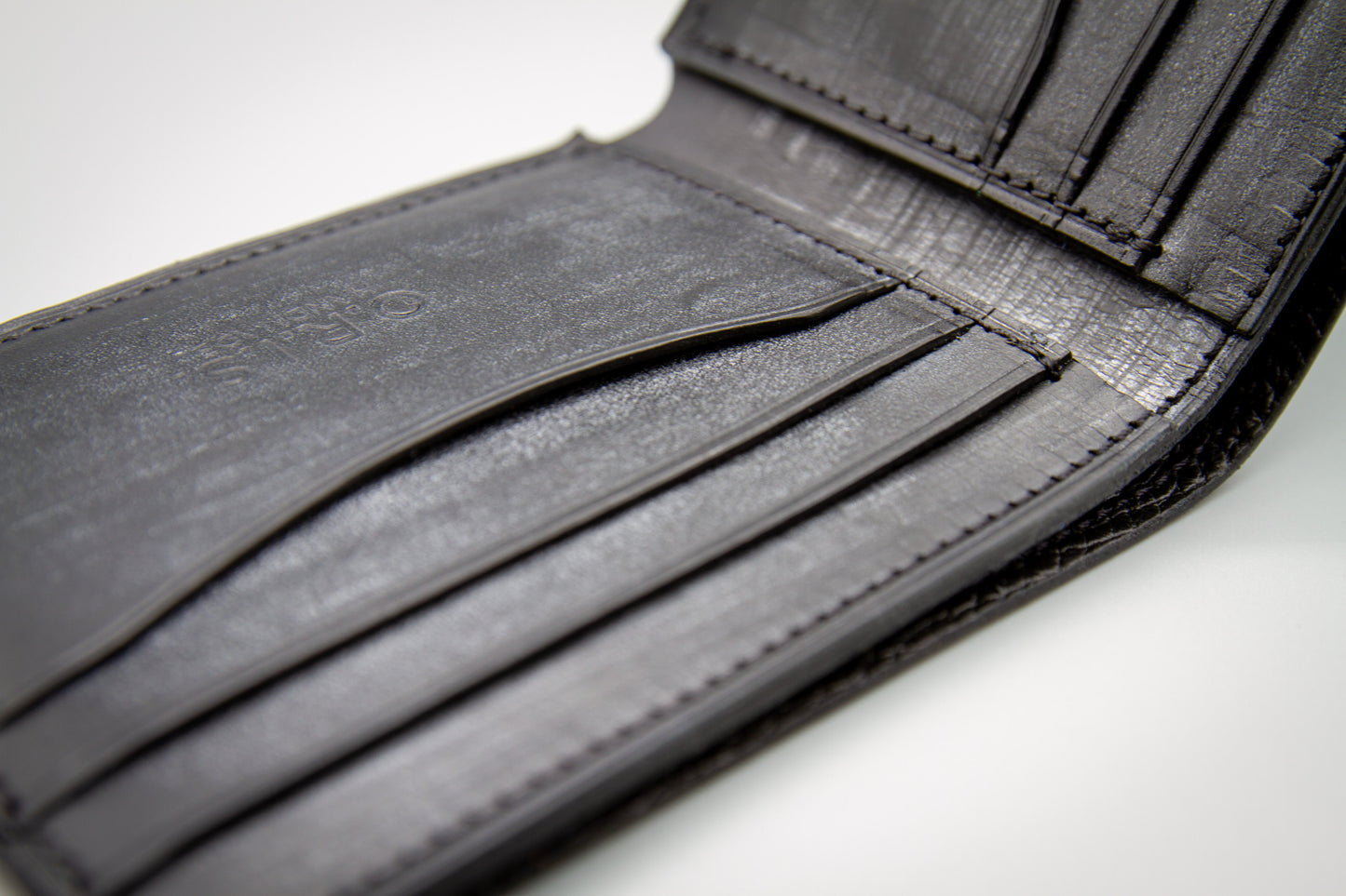 
                  
                    Close-up of hand-stitched construction and hand-burnished edges on Italian Belfagor leather wallet
                  
                