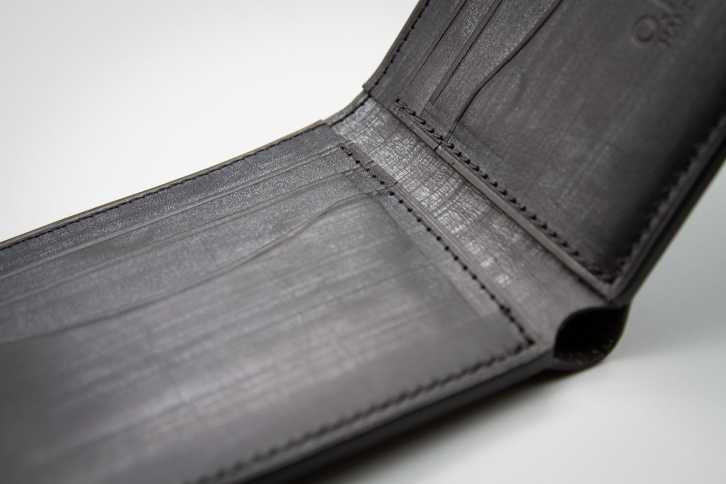 
                  
                    Close-up of clean stitching along the border of Italian Belfagor leather wallet
                  
                
