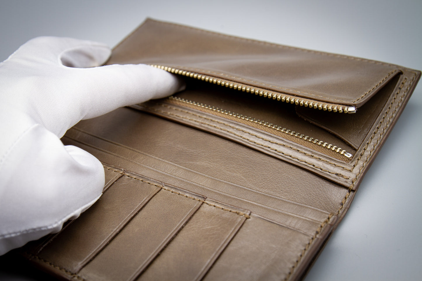 
                  
                    Overhead view of the open wallet displaying card slot organization and full-length bill pockets.
                  
                
