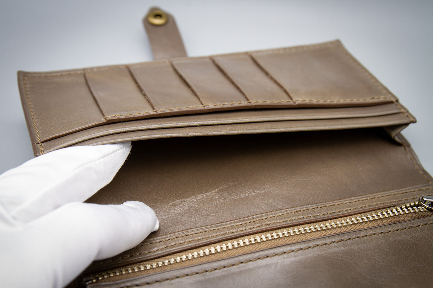 
                  
                    Detailed shot of the cowhide coin pocket showing clean seam alignment and stitch lines.
                  
                