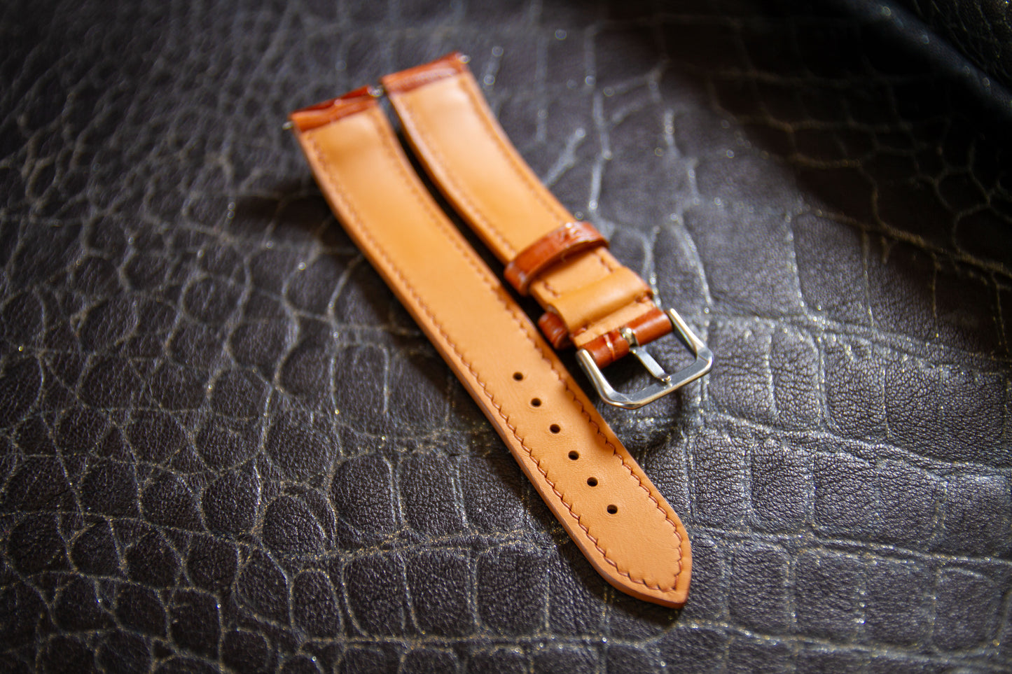 
                  
                    Underside view of cognac alligator watch strap showing water-resistant tan Zermatt leather lining, reinforced adjustment holes, and clean perimeter hand stitching
                  
                