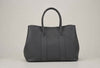 360-degree rotating view of a handcrafted gray Togo leather voyager tote bag showing all exterior angles, base, and rolled handles.